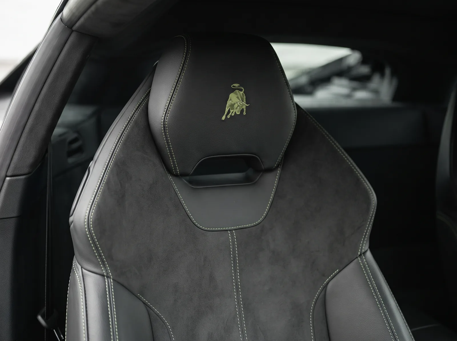 AI-generated illustration of a Lamborghini sports-seat headrest with black upholstery and green stitching